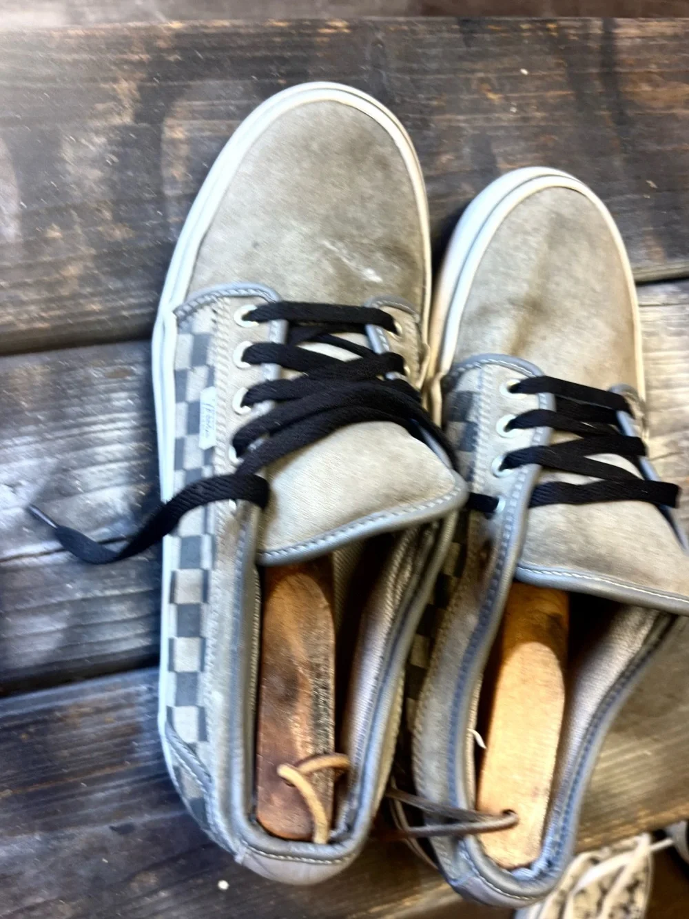 Vans gray suede sneakers with black & white checkerboard pattern on the side